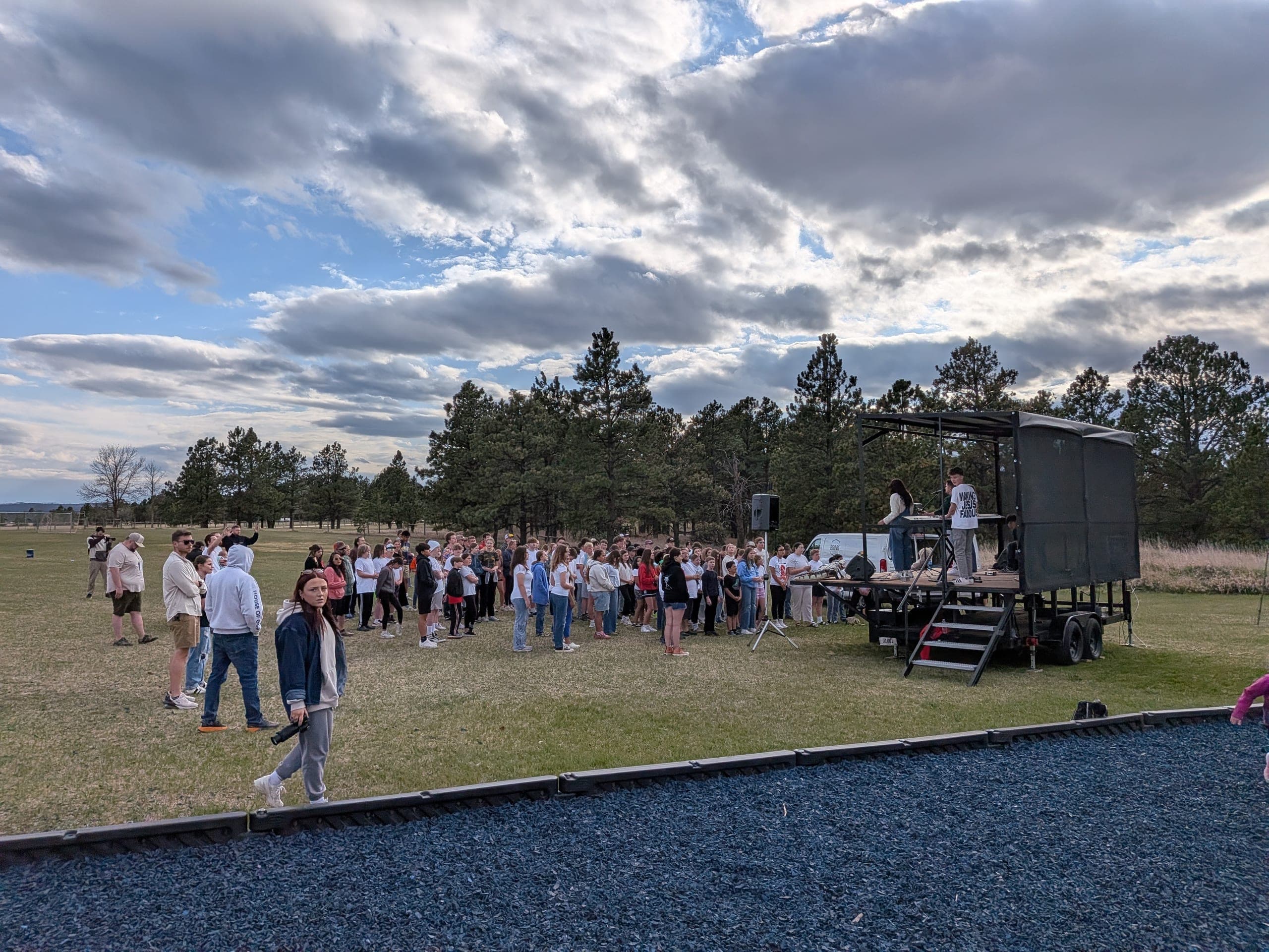 Students gathered in front of the trailer stage during the worship set at UNITE Black Hills Spring 2026 in Rapid City